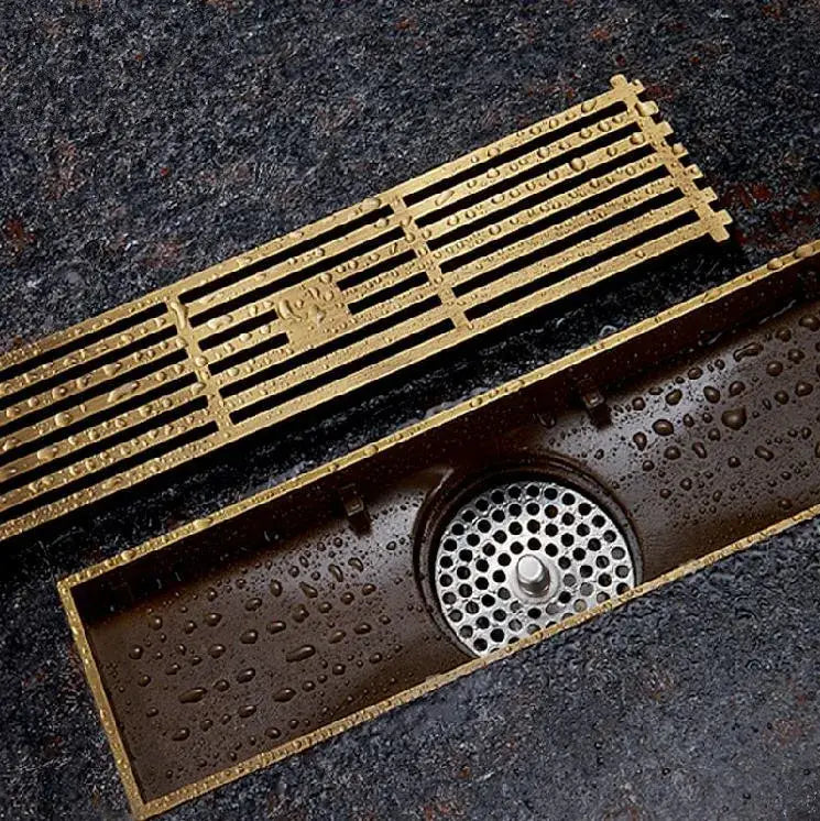 Antique brass linear shower floor drain with carved cover for bathroom