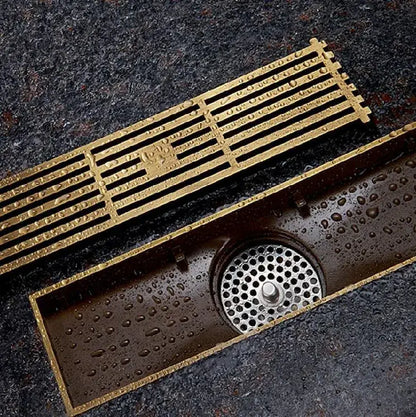 Antique brass linear shower floor drain with carved cover for bathroom