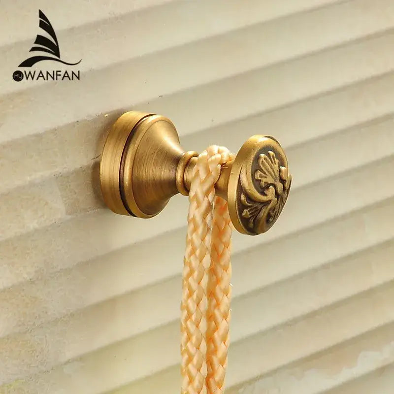 Antique brass robe hook with floral engraving and rope bathroom hook
