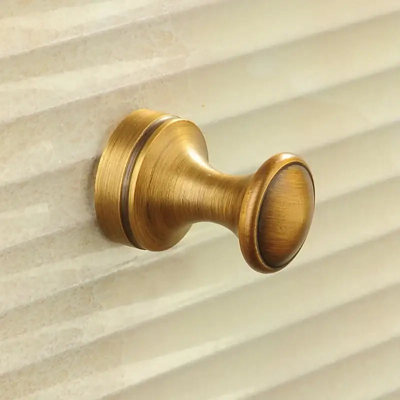 Antique brass robe hook with floral engraving and rope bathroom hook