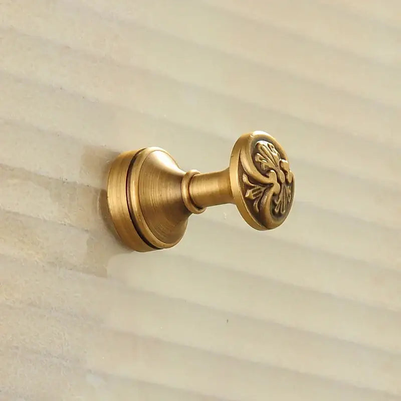 Antique brass robe hook with floral engraving and rope bathroom hook