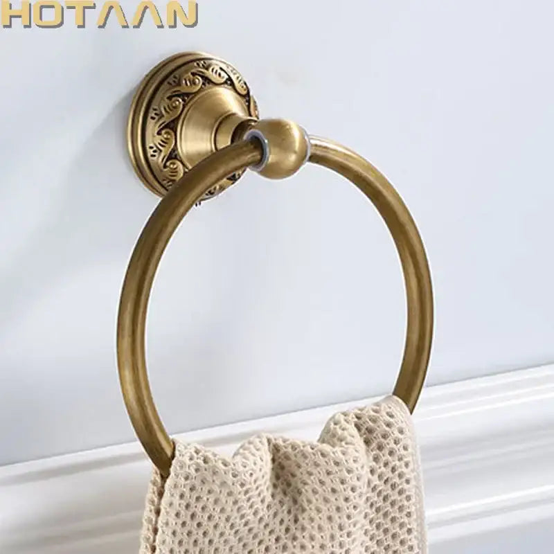 Antique brass round towel ring with ornate leaf mount for bathroom