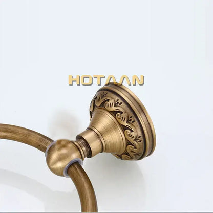 Antique brass round towel ring with ornate leaf mount for bathroom