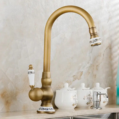 Antique brass swivel spout kitchen faucet with floral ceramic handle
