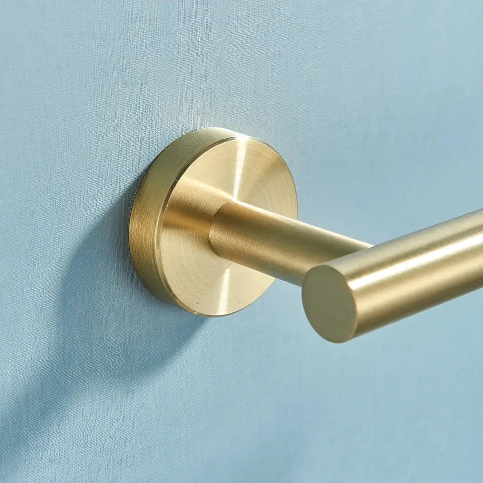 Modern brass bathroom hardware set with cylindrical towel rack