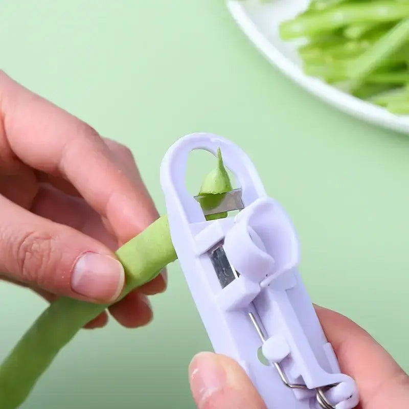 White plastic bean slicer cutter peeler for kitchen green beans