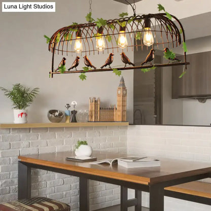 Rustic black birdcage pendant light dining room with vine and birds