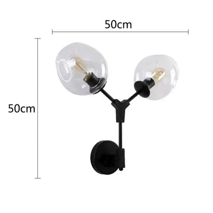 Modern black & gold wall lamps with frosted glass globes for bedroom