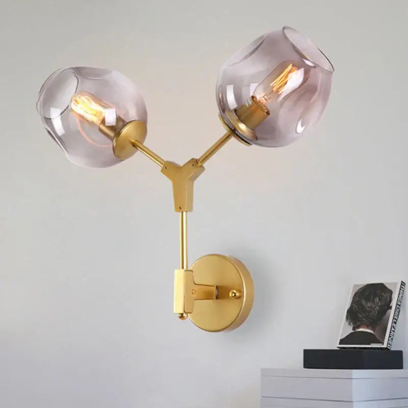 Modern black & gold wall lamps with frosted glass globes for bedroom