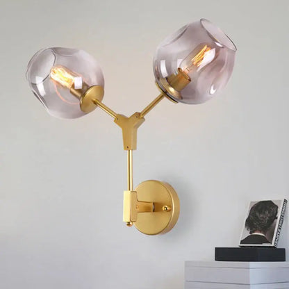 Modern black & gold wall lamps with frosted glass globes for bedroom