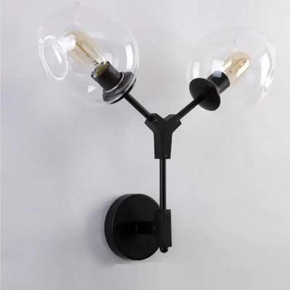 Modern black & gold wall lamps with frosted glass globes for bedroom