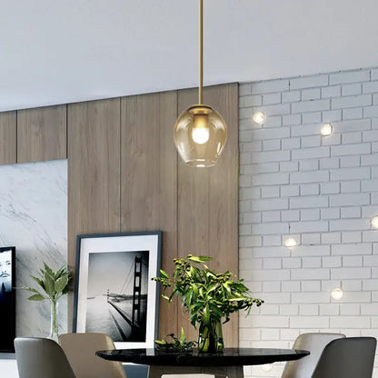 Modern black & gold wall lamps with frosted glass globes for bedroom