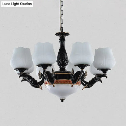 Ornate black & gold chandelier with frosted glass shades dining room