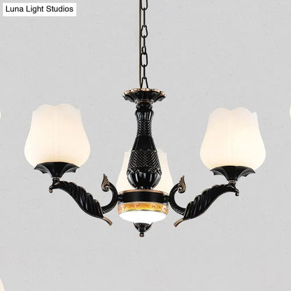 Ornate black & gold chandelier with frosted glass shades dining room