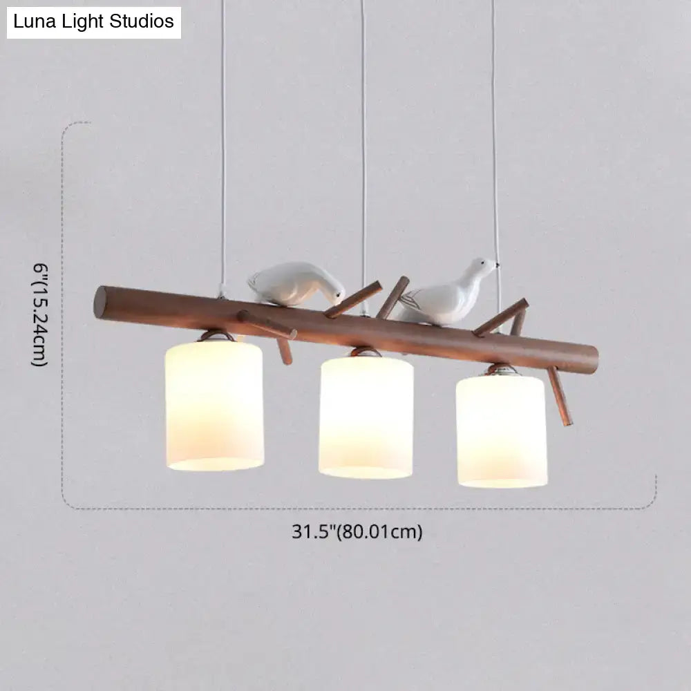 Modern wood island pendant with birds and cylindrical glass kitchen light