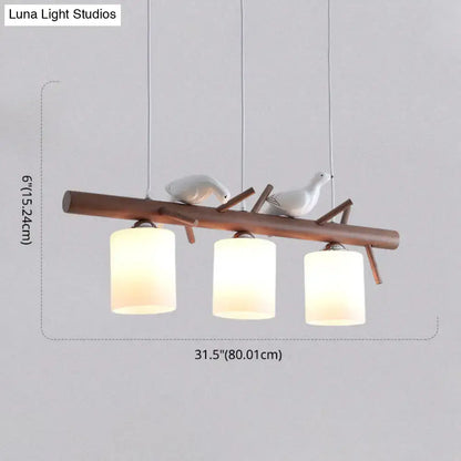 Modern wood island pendant with birds and cylindrical glass kitchen light