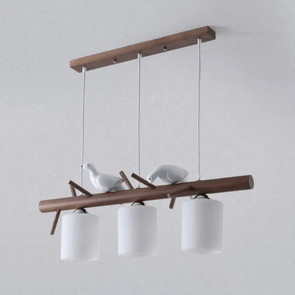 Modern wood island pendant with birds and cylindrical glass kitchen light