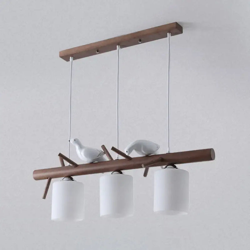 Modern wood island pendant with birds and cylindrical glass kitchen light