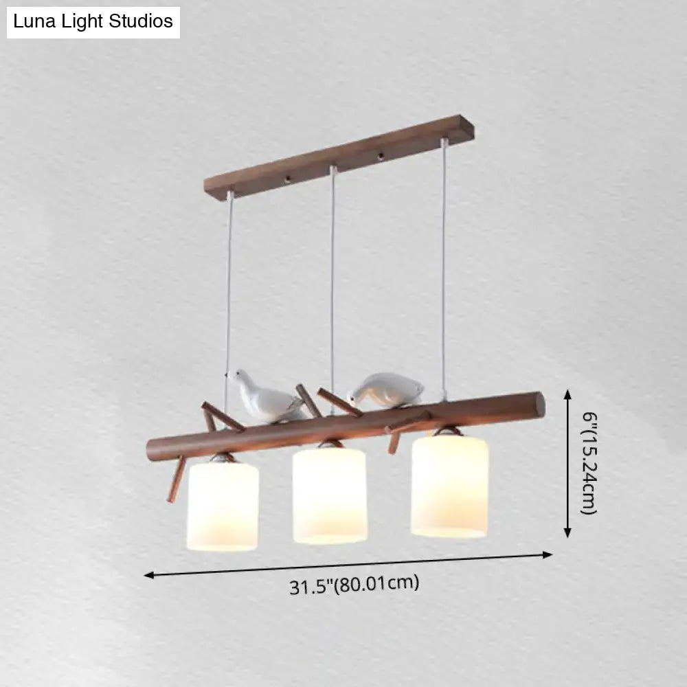 Modern wood island pendant with birds and cylindrical glass kitchen light
