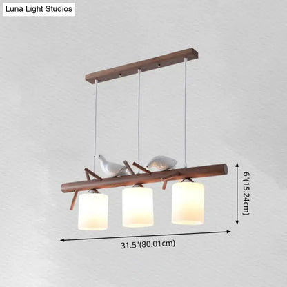 Modern wood island pendant with birds and cylindrical glass kitchen light