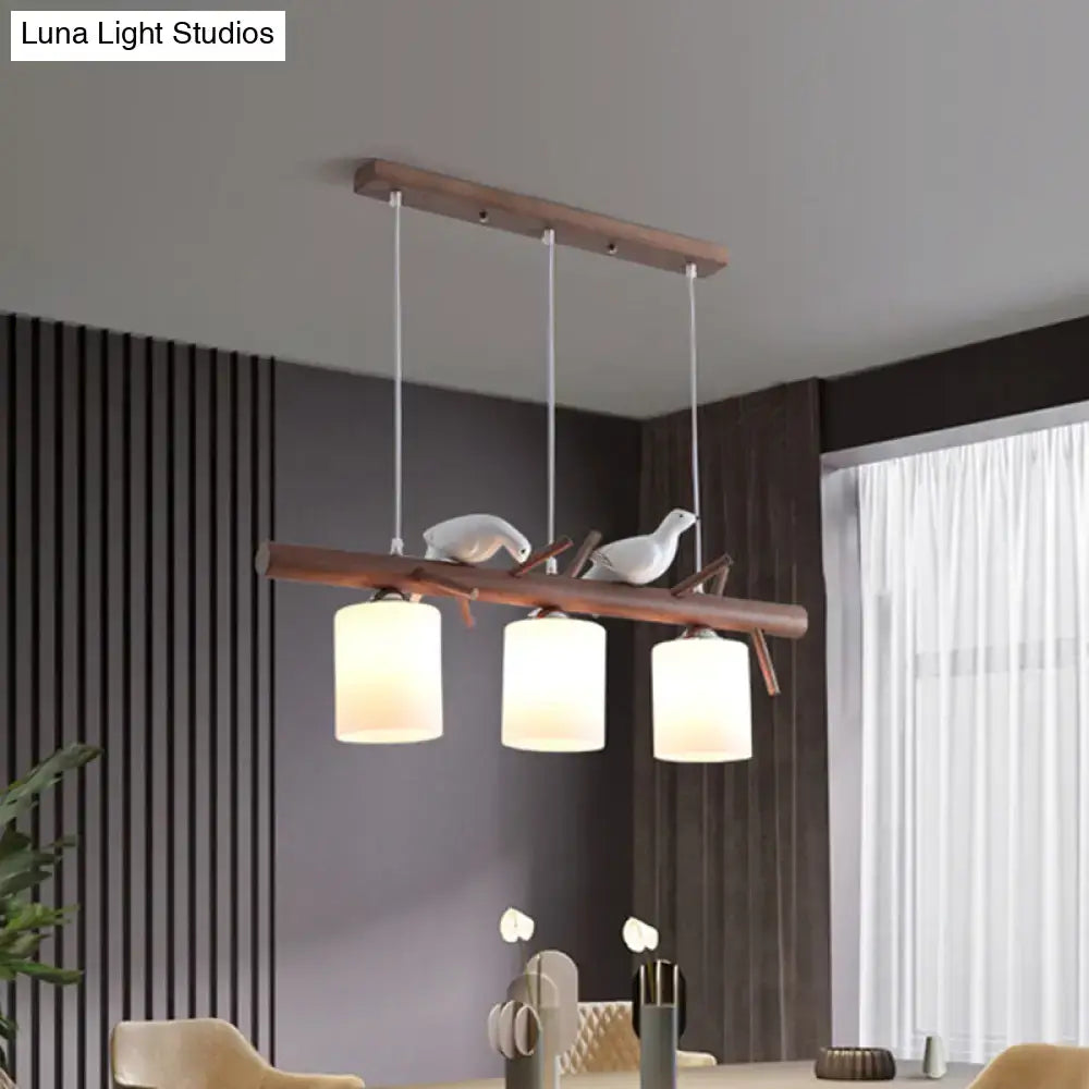 Modern wood island pendant with birds and cylindrical glass kitchen light