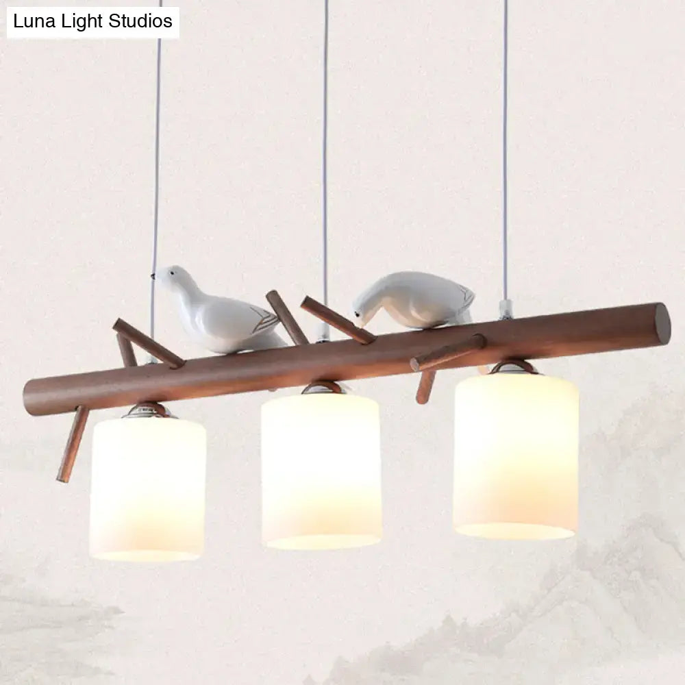Modern wood island pendant with birds and cylindrical glass kitchen light