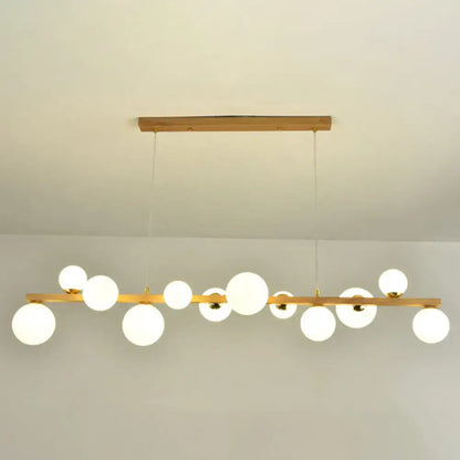 Modern gold and wood pendant with frosted globe shade dining room