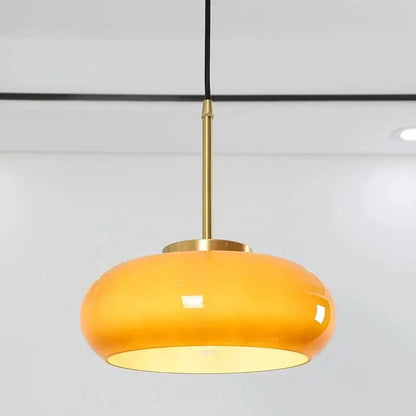 Sleek amber glass and copper pendant light for kitchens