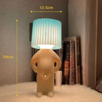 Whimsical beige and yellow naughty boy table lamp for bedroom bedside
