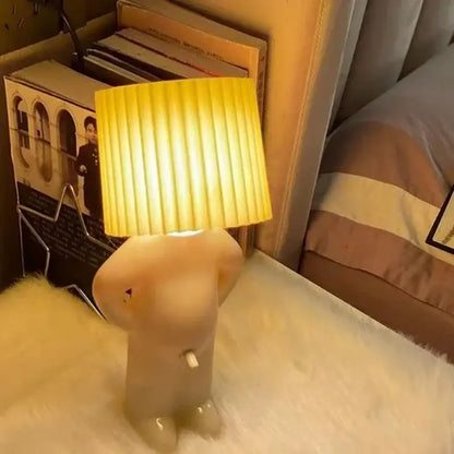 Whimsical beige and yellow naughty boy table lamp for bedroom bedside