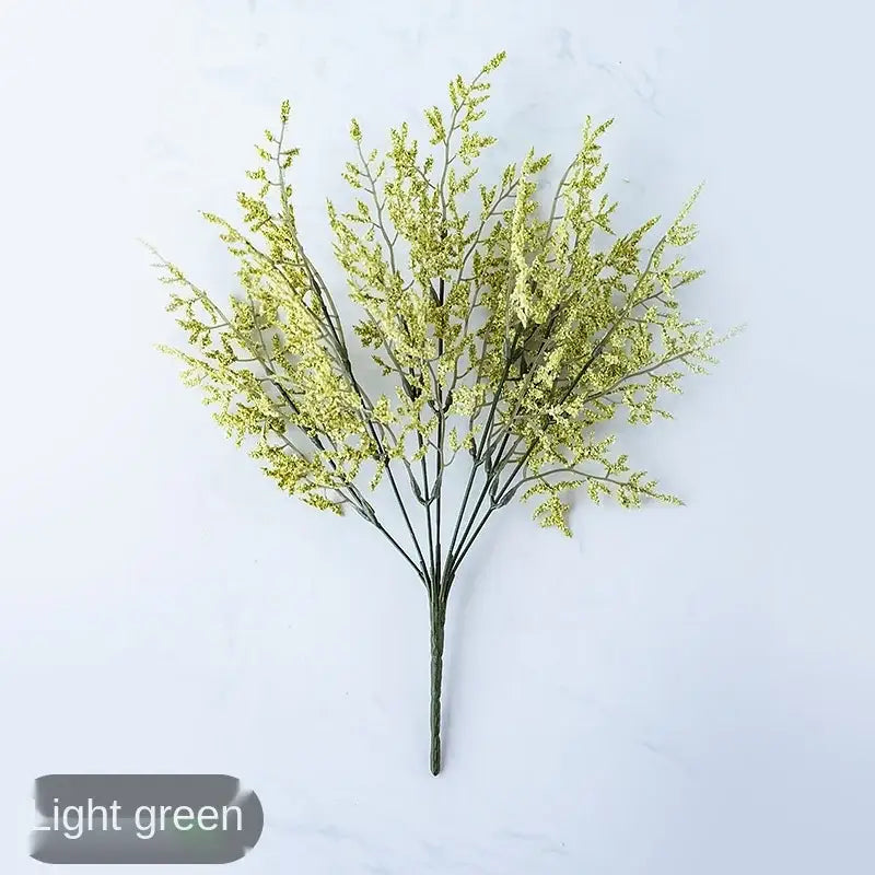 Mint green ceramic vase with yellow lemon grass branch living room