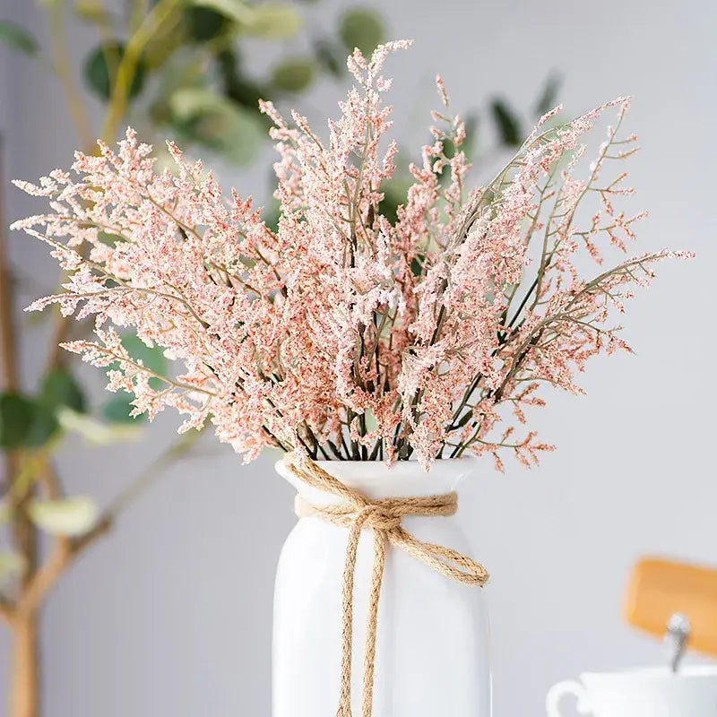 Mint green ceramic vase with yellow lemon grass branch living room
