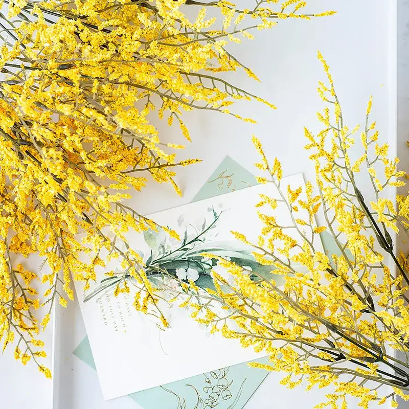 Mint green ceramic vase with yellow lemon grass branch living room