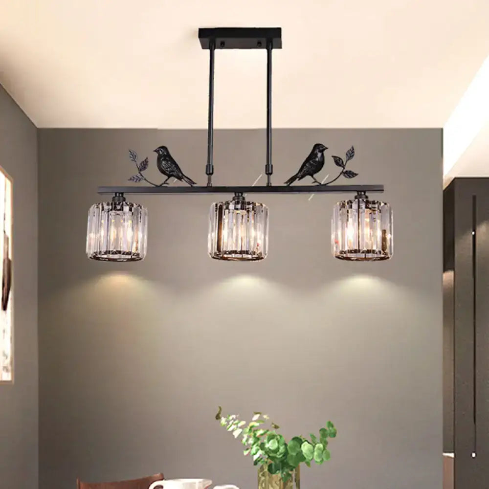 Black crystal prism island light fixture with leaf decor dining room