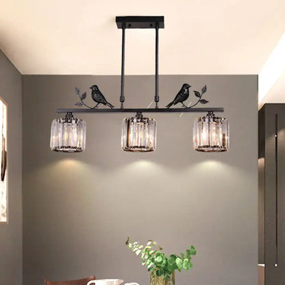 Black crystal prism island light fixture with leaf decor dining room