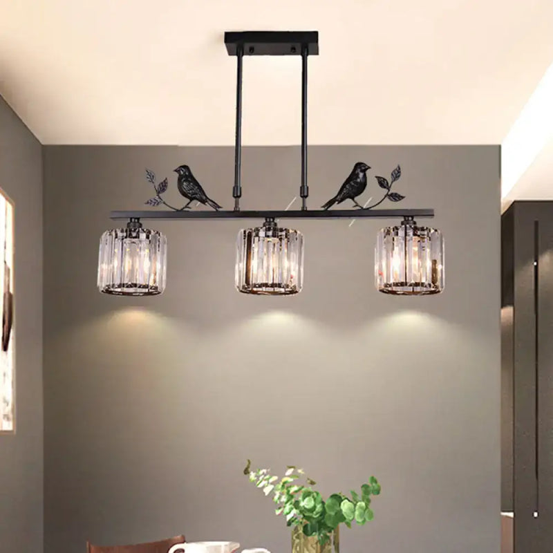 Black crystal prism island light fixture with leaf decor dining room