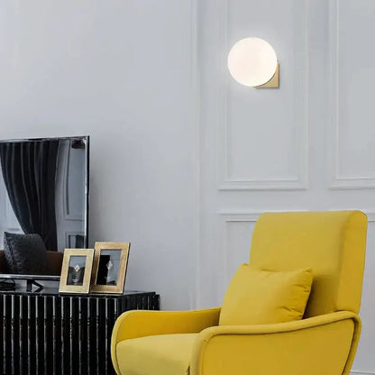 Minimalist brass and glass ball art wall lamp for bedroom