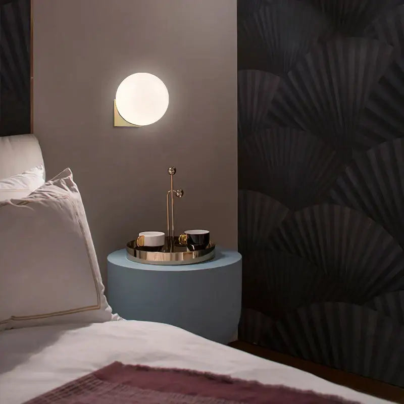 Minimalist brass and glass ball art wall lamp for bedroom