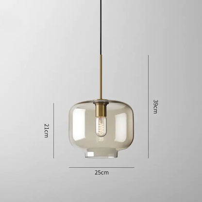 Modern smoked glass pendant lights with brass accents for kitchen island