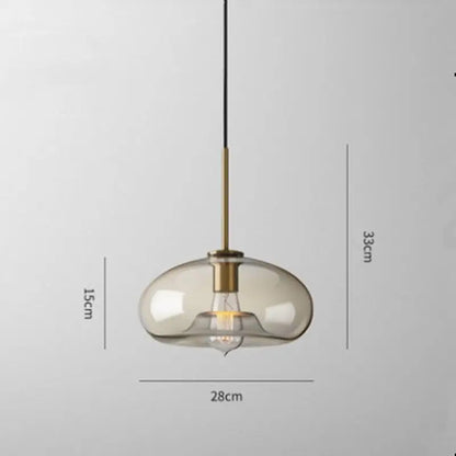 Modern smoked glass pendant lights with brass accents for kitchen island