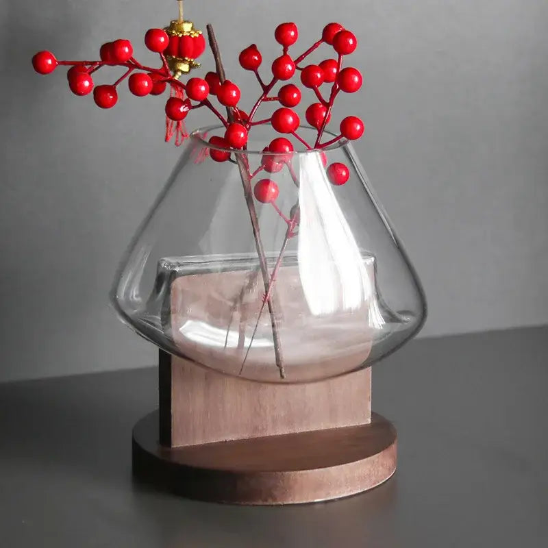 Minimalist clear glass vase with red berries and wood base living room