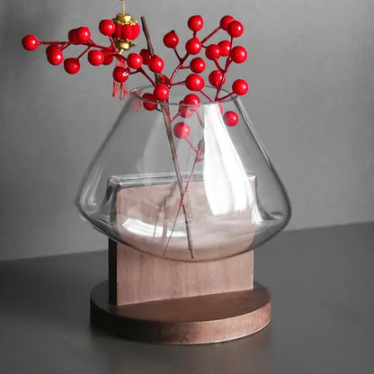 Minimalist clear glass vase with red berries and wood base living room