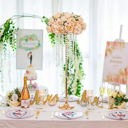 Elegant gold metal vases with crystals and roses for dining room