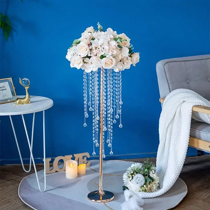 Elegant gold metal vases with crystals and roses for dining room