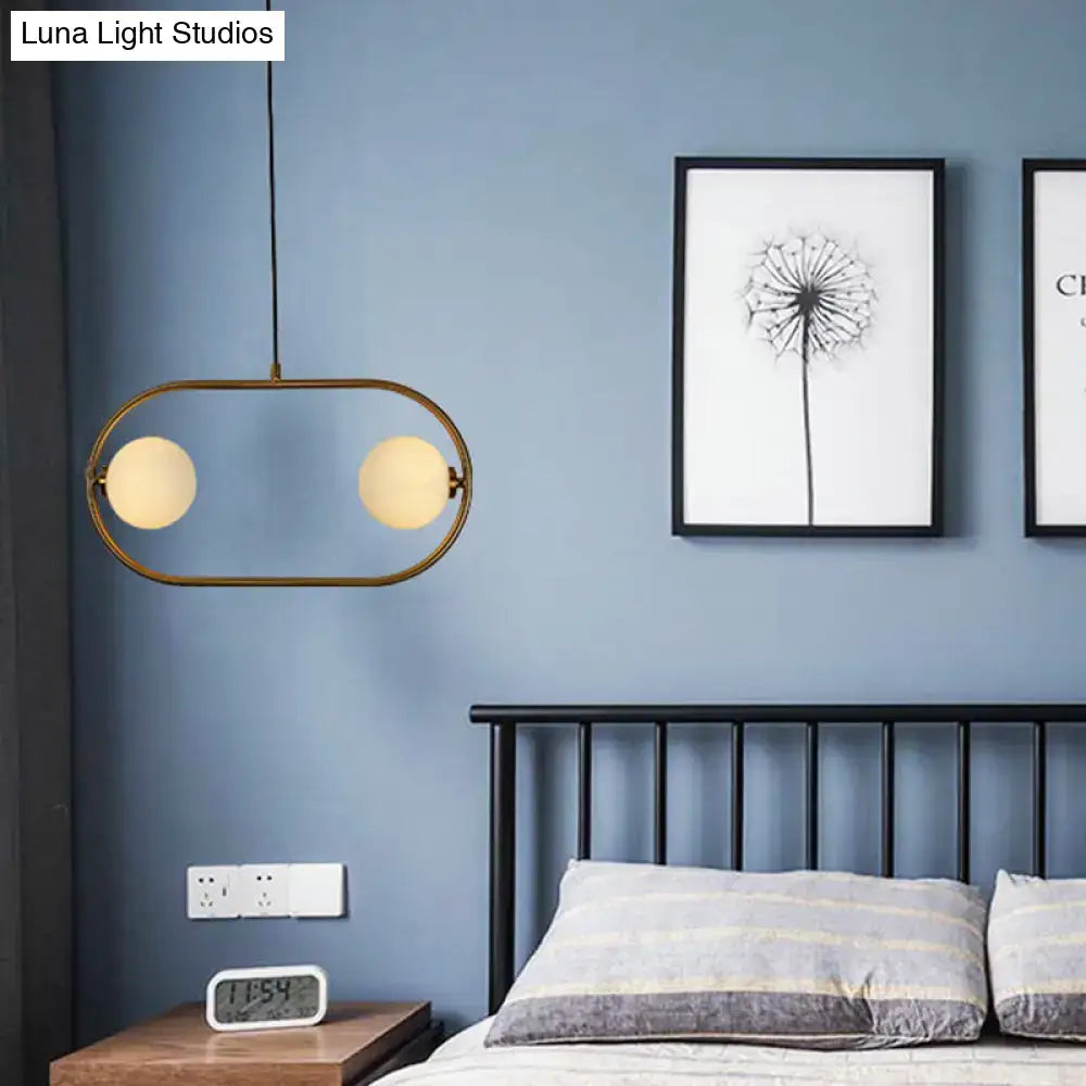 Modern gold globe hanging chandelier with frosted glass – bedroom