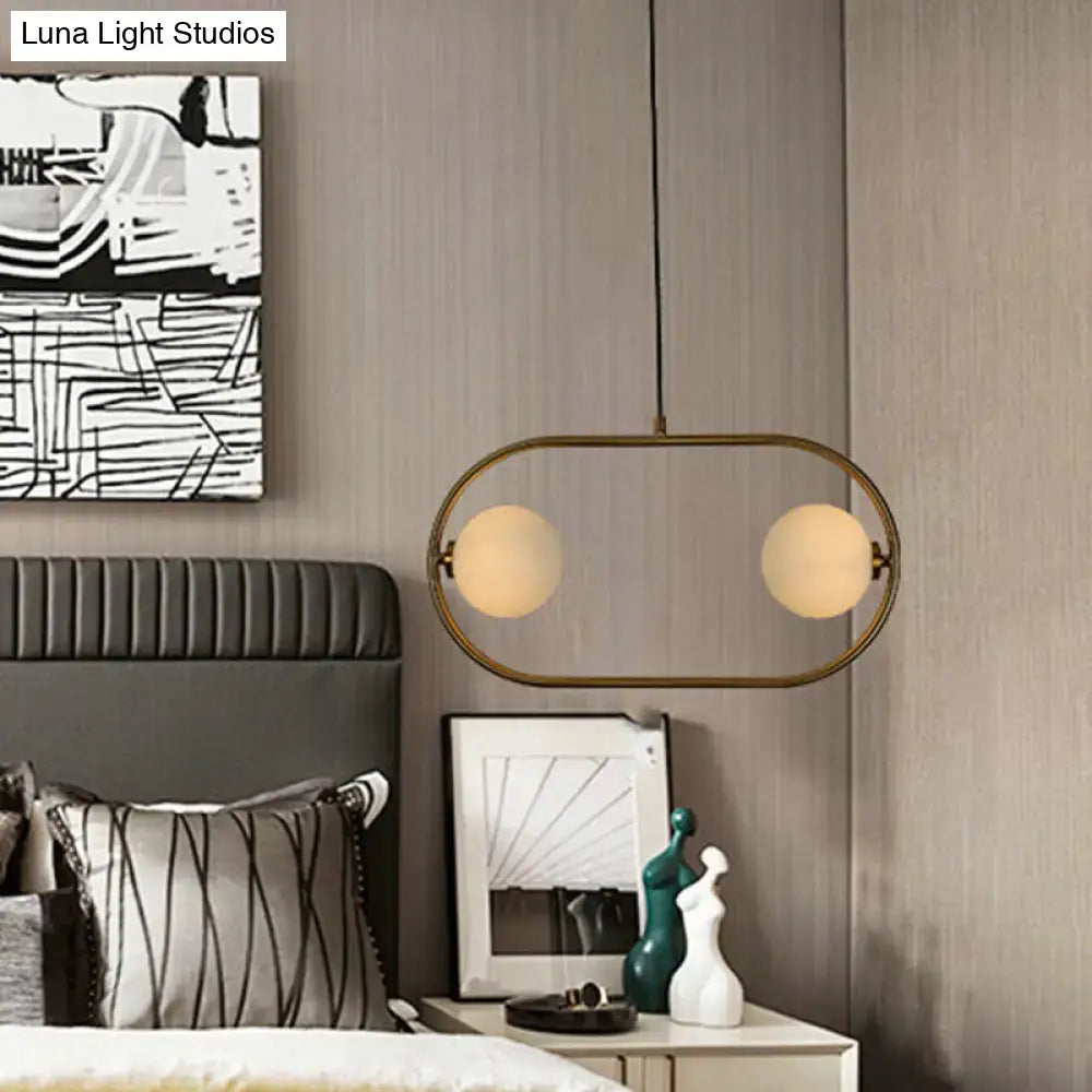Modern gold globe hanging chandelier with frosted glass – bedroom