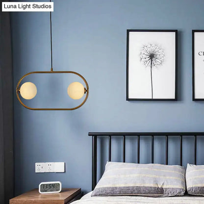 Modern gold globe hanging chandelier with frosted glass – bedroom