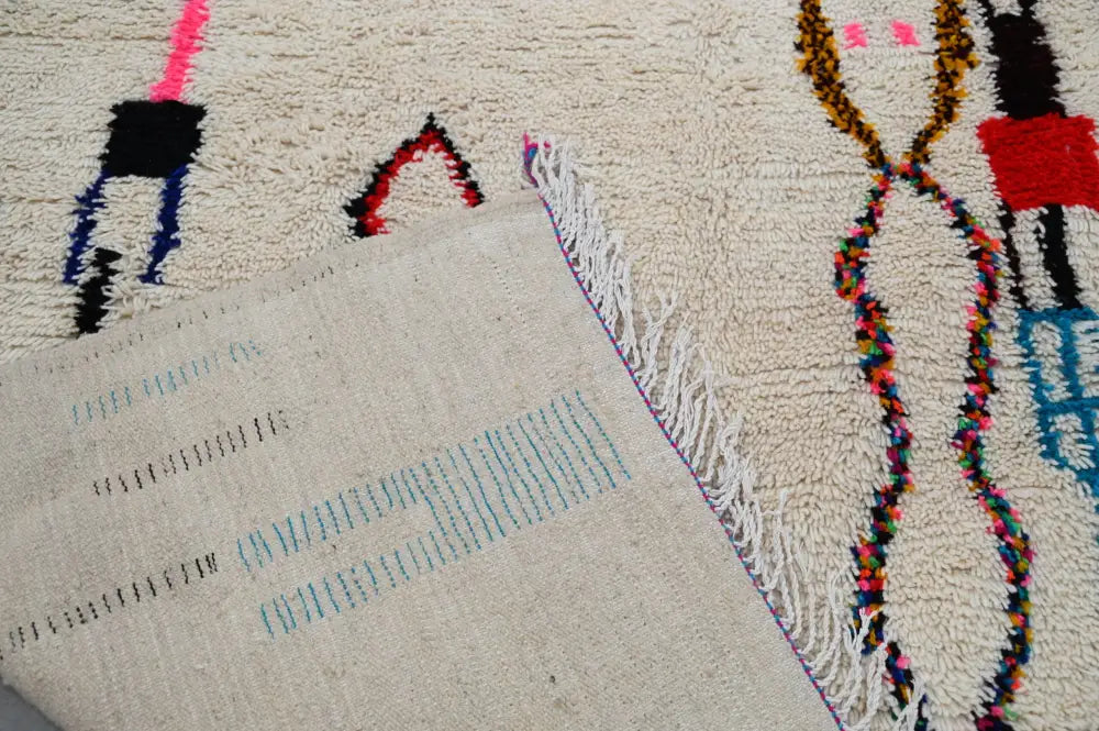 Beige moroccan azilal rug with vibrant geometric patterns bedroom decor