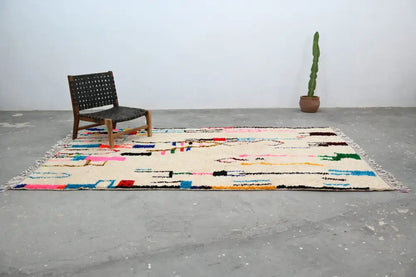 Beige moroccan azilal rug with vibrant geometric patterns bedroom decor