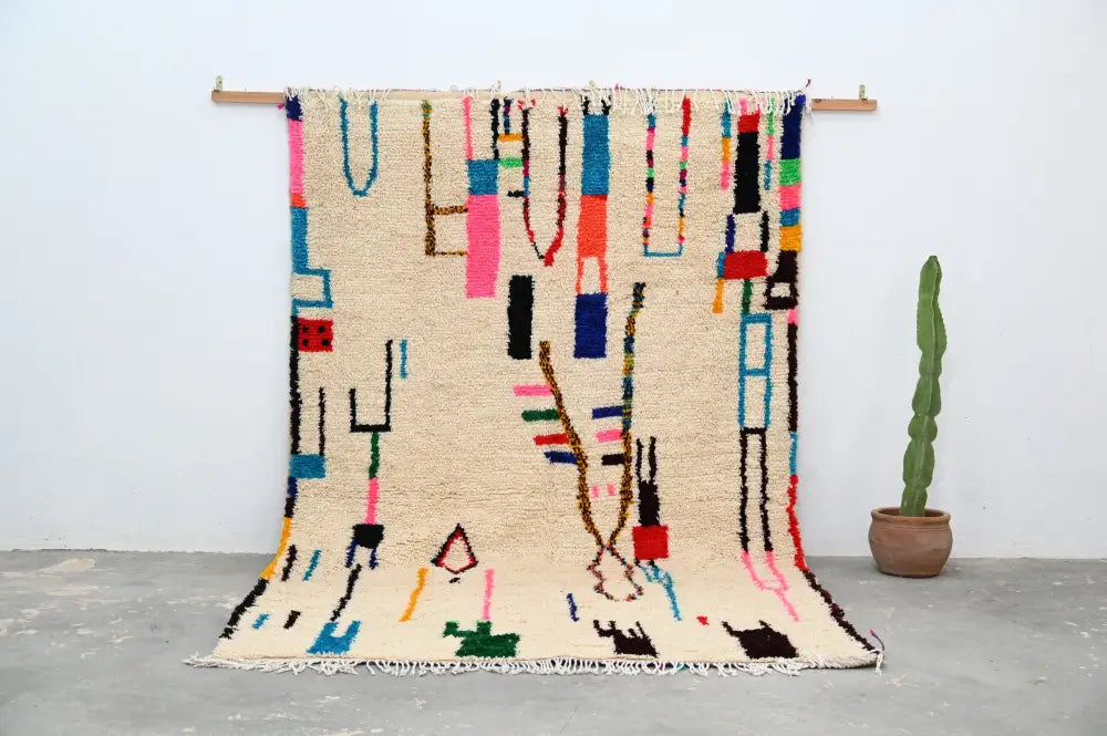 Beige moroccan azilal rug with vibrant geometric patterns bedroom decor